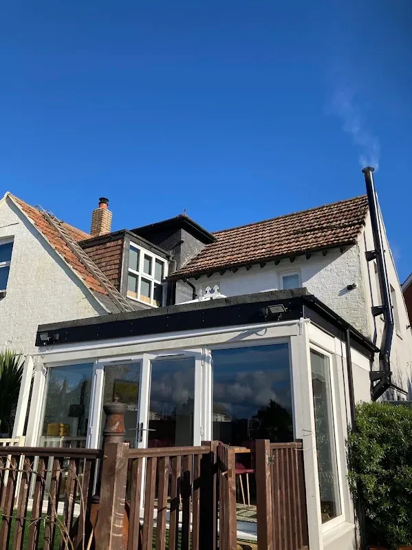 Completed flat roof above a glazed rear extension on a Kent home