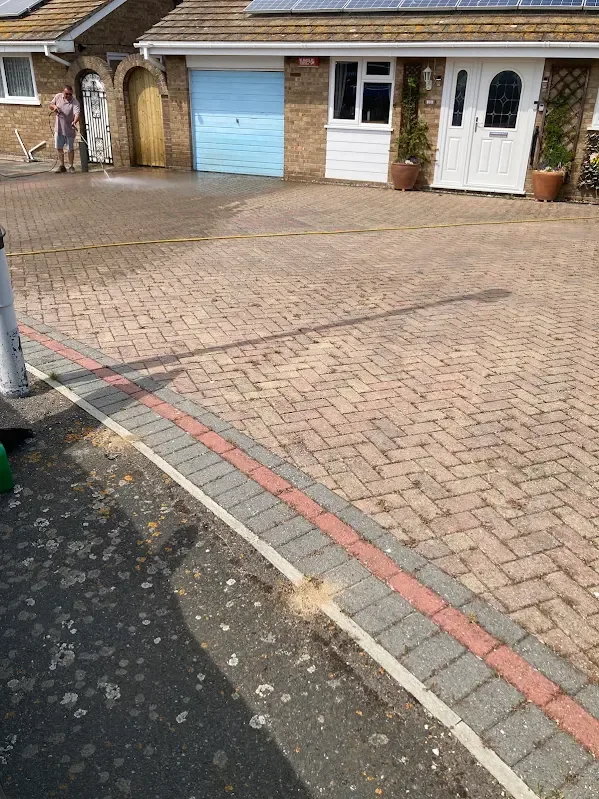 Pressure washing a block paved driveway outside a Kent bungalow