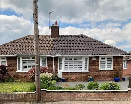 Brick bungalow with a tiled roof and chimney in Kent
