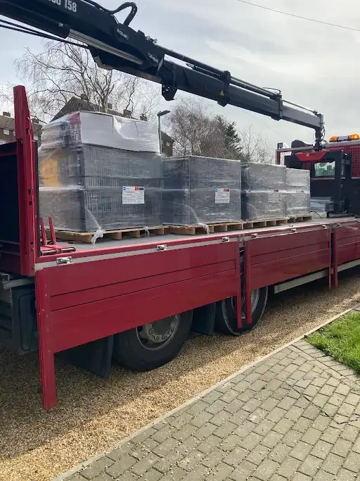 Pallets of new roof tiles delivered on a crane lorry for a Kent re-roof