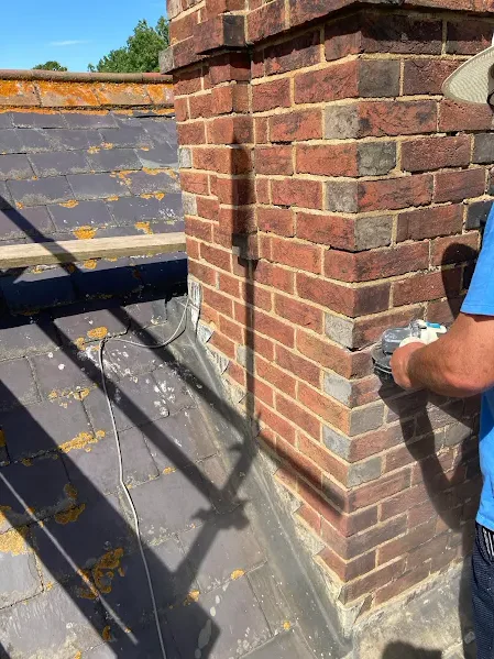 Repointing the base of a brick chimney above a slate roof