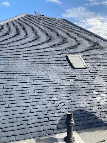 Clean slate roof with skylight after roof cleaning