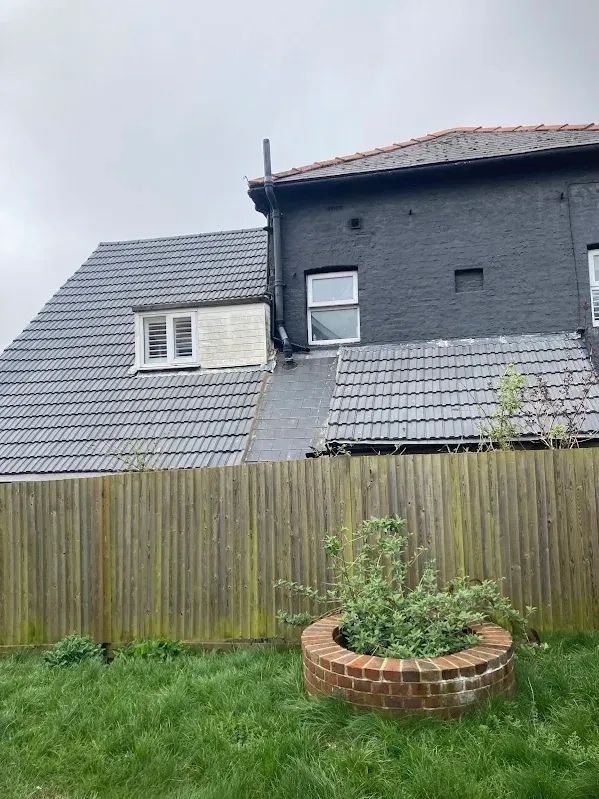 Completed new grey tiled roof on a Kent house
