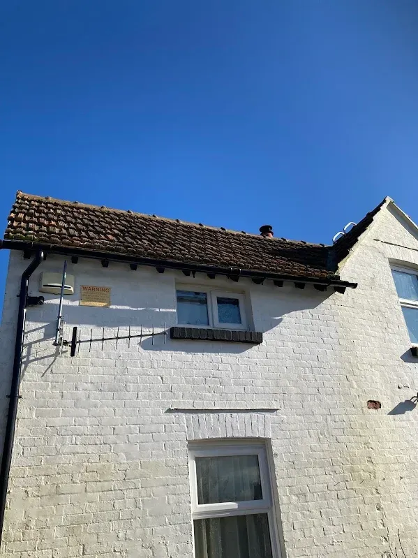 UPVC Fascias, Soffits & Guttering: New uPVC fascias, soffits and dark guttering on a painted brick house in Kent